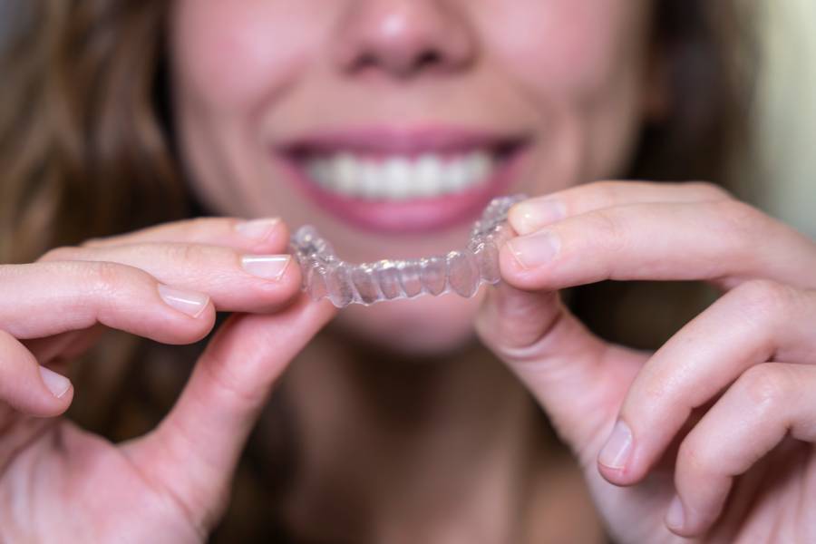 A patient holding Invisalign